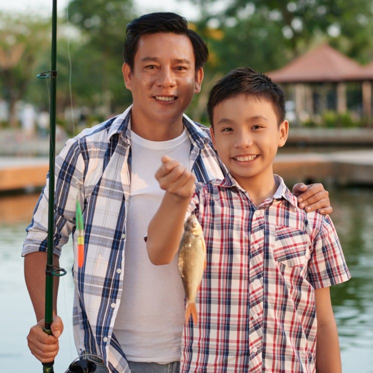 Boy and father fishing